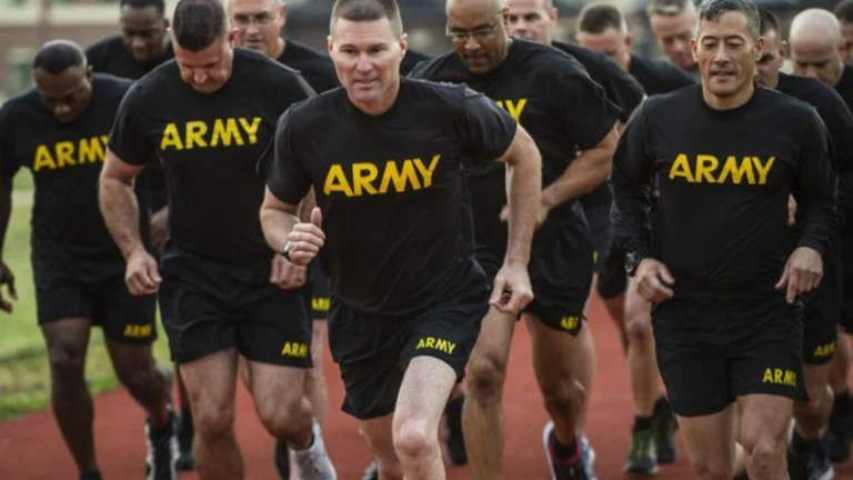 ACFT Calculator | Calculate Your Army Combat Fitness Test Score 3 US Army soldiers in black "ARMY" shirts running on a track during the Two-Mile Run (2MR) event of the ACFT